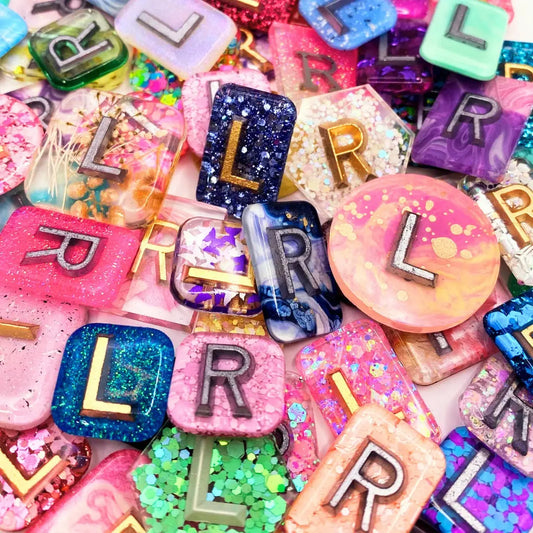 A pile of colourful X-RayMarkers made of different types of glitter.