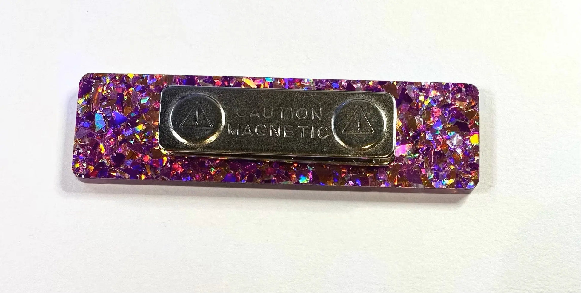 a metal object with a purple and red speckled surface