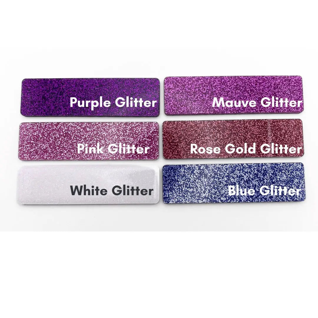 a set of five purple glitter name tags