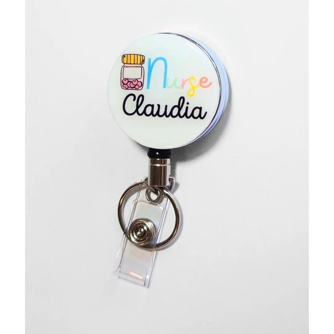 Custom Heavy duty badge reel with a tablet container of hearts and the word Nurse at the top. This reel is able to be customised with a name at the bottom in thin black font.