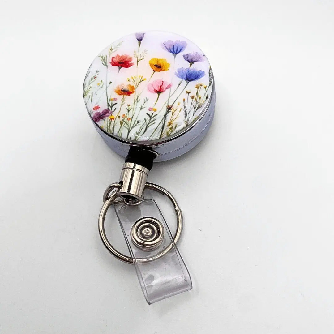 a round metal object with flowers painted on it