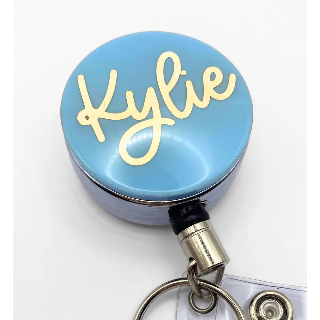 a blue round badge with the word kyllie on it