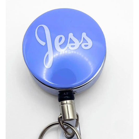 a blue keychain with the word jesus on it