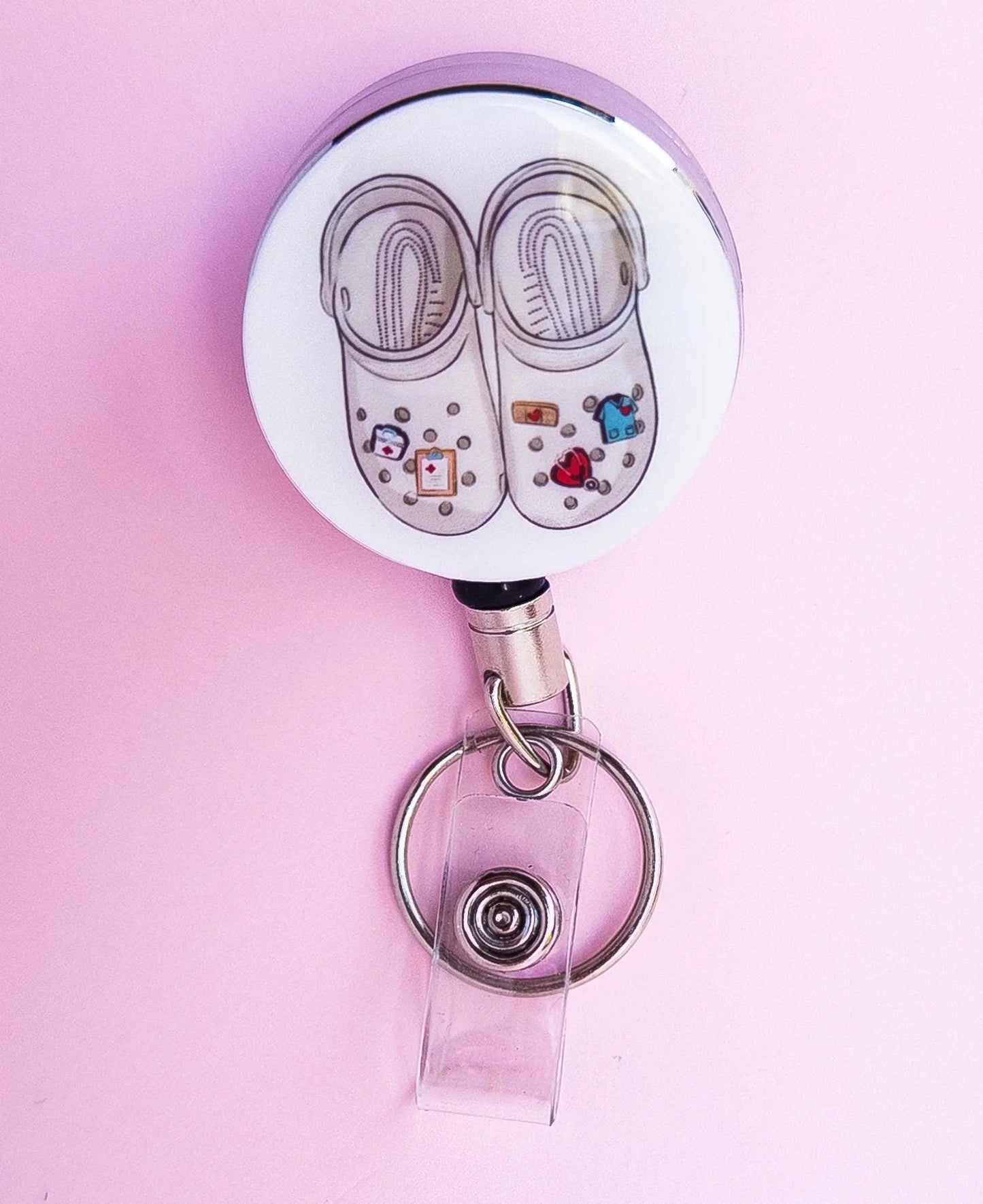 Theatre shoes on a heavy duty badge reel for nurses.