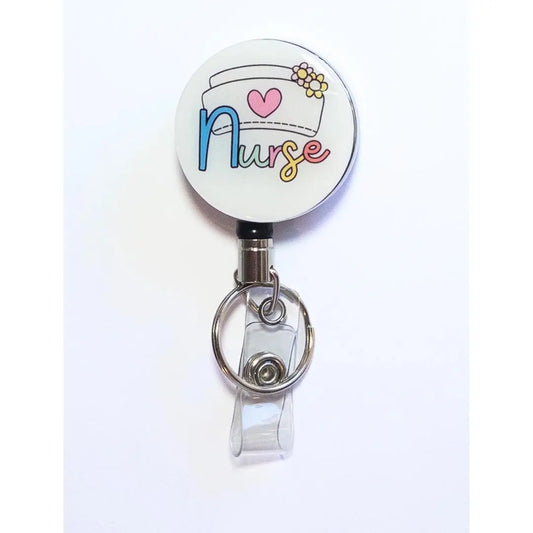 Heavy Duty badge reel with nursing hat and the word nurse in cute colours.