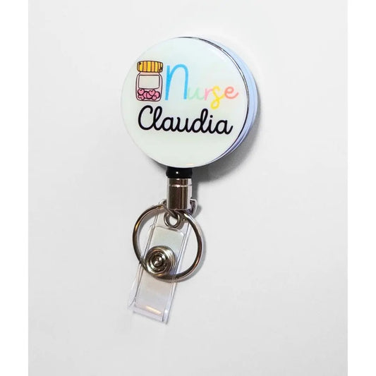 Custom Heavy duty badge reel with a tablet container of hearts and the word Nurse at the top. This reel is able to be customised with a name at the bottom in thin black font.