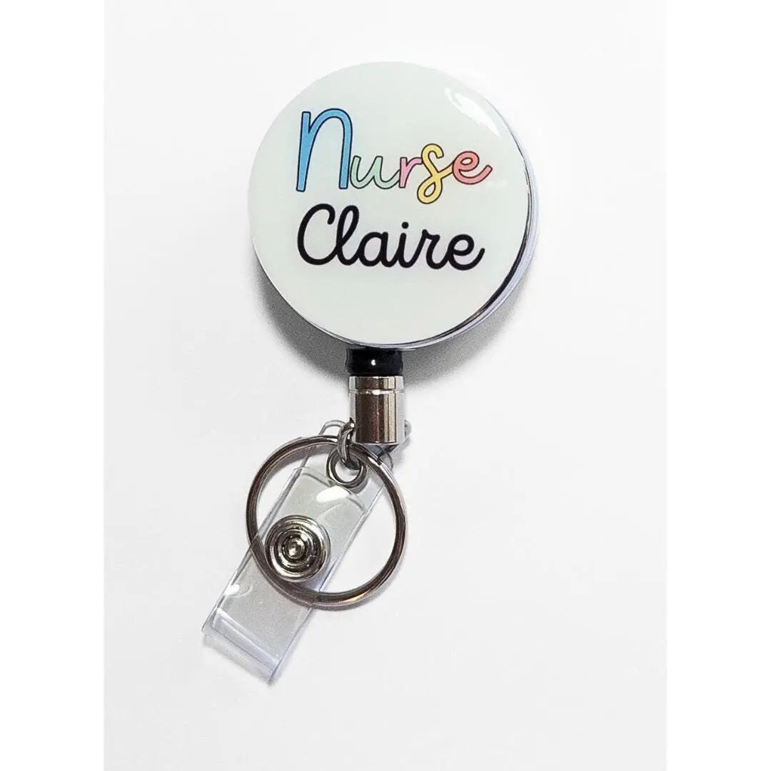Heavy duty badge reel for nurses, with the word nurse in colourful writing and the name Claire underneath in black cursive and a white background.